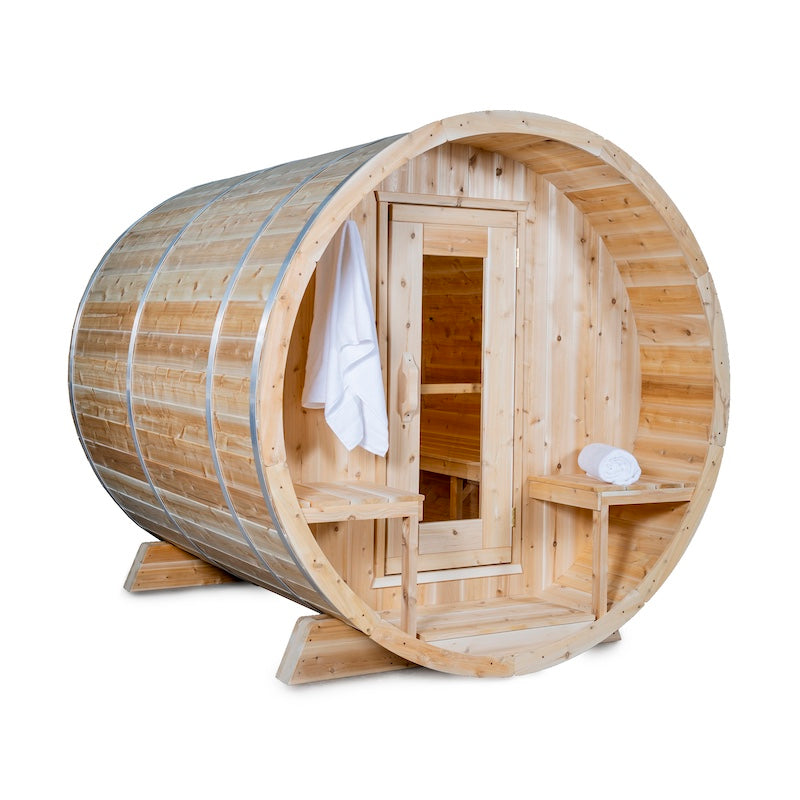 An outdoor cedar barrel sauna with a glass door and a porch.
