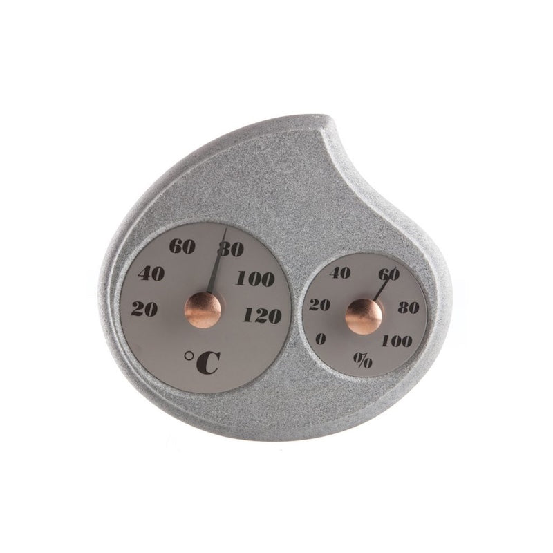 A soapstone sauna thermometer and hydrometer with brass details.