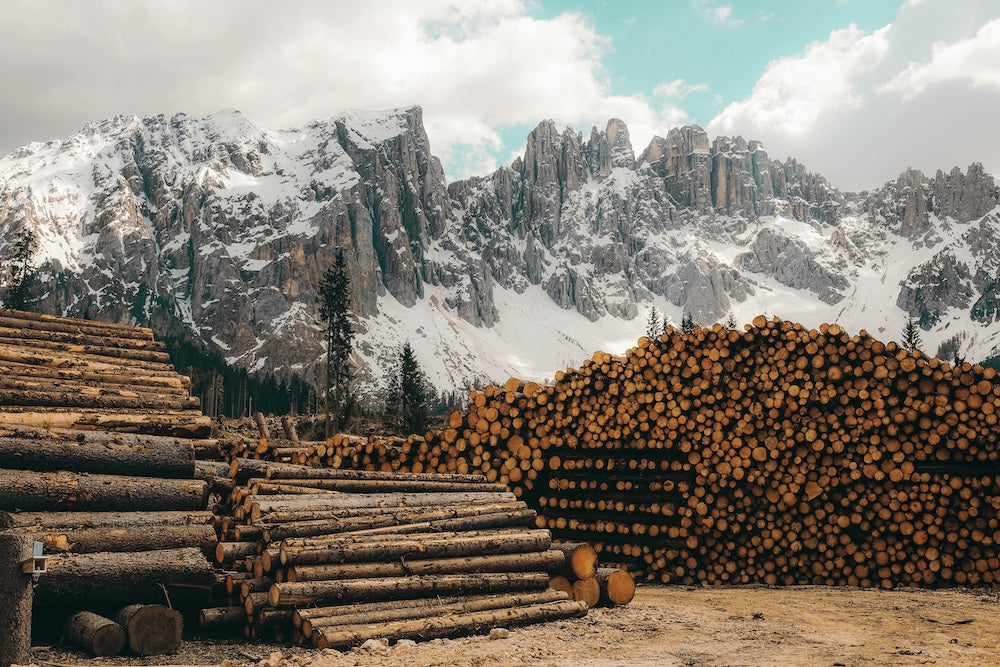 A lumber yard of sauna lumber with mountains in the background.