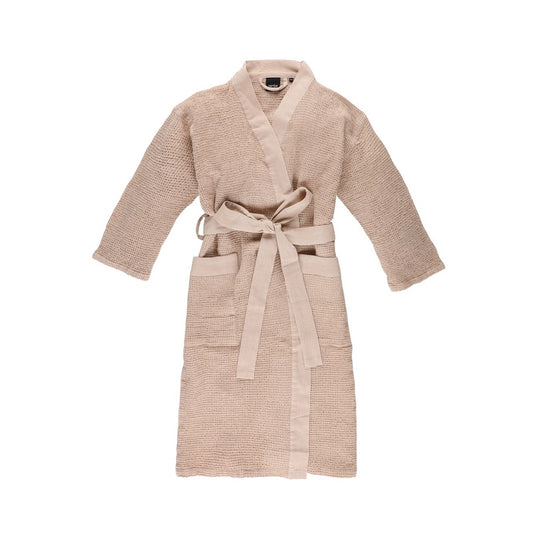 The front of a beige waffle knit bath robe used in saunas.