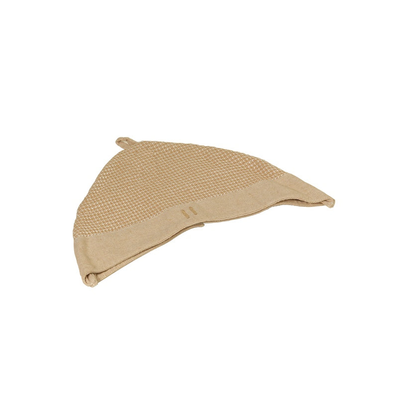 A beige, waffle knit sauna hat.