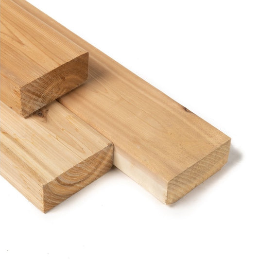 Three cedar 2x4 planks used for sauna construction.