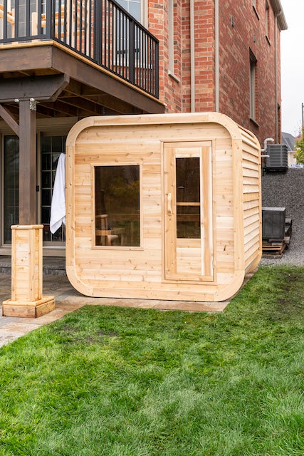 The front of a Henki Cube Sauna under a deck in Ontario.