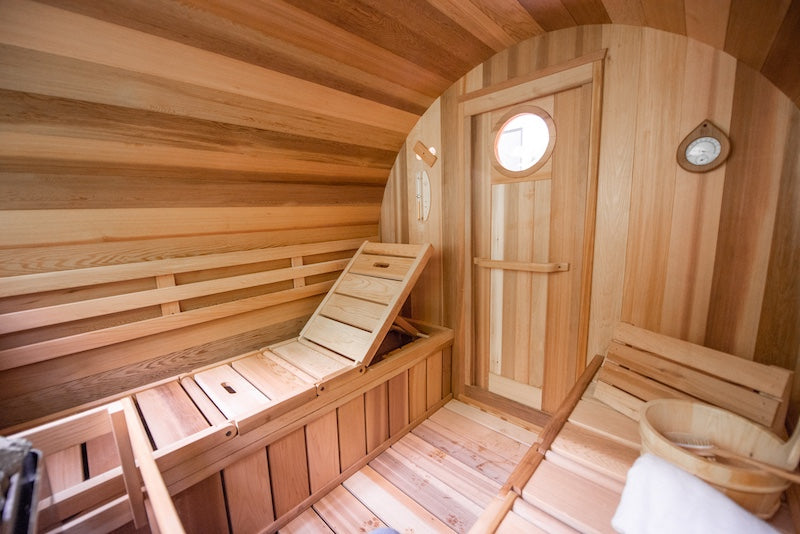 The inside of a Custom Barrel Sauna from Henki Sauna showcasing the adjustable lounge benches. 