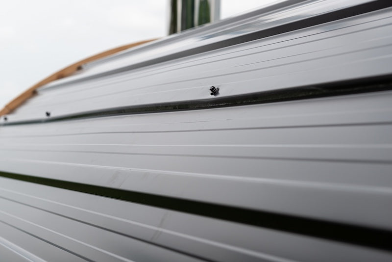 A close up of the black metal roof on a Henki barrel sauna.