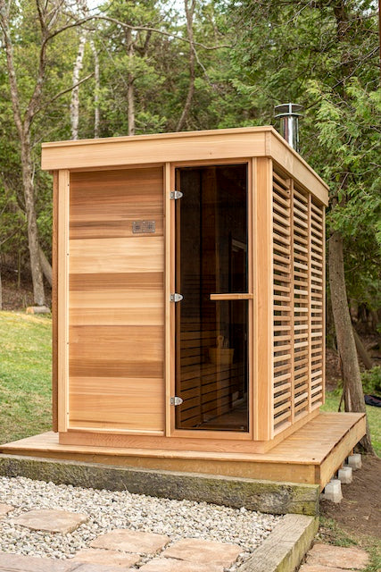 The left side of a Custom Pure Cube Sauna on a deck in an Ontario backyard.
