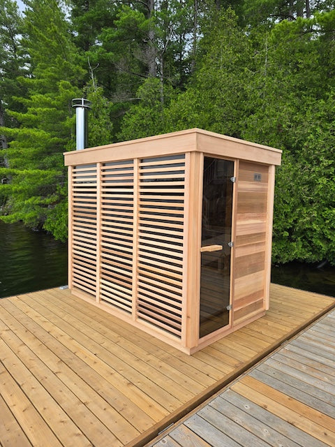 A Custom Pure Cube Sauna from Henki on a floating dock in Ontario.