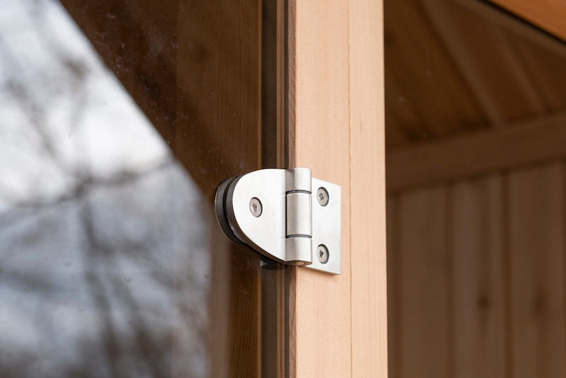 The stainless steel hinge of a Henki Tempered Glass Sauna Door.
