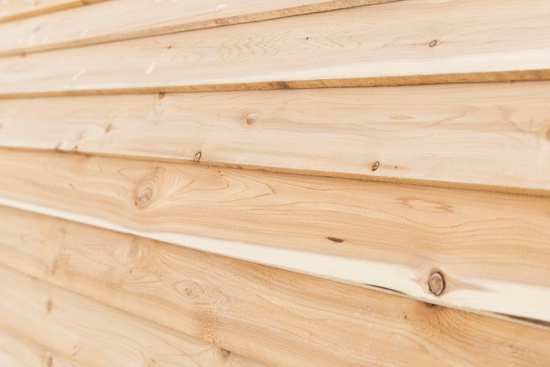 A close up of the bevel cedar siding used on a Henki barrel sauna.