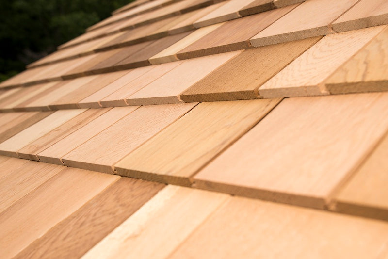 The cedar shake shingles on a Henki Modern Cabin Sauna roof.
