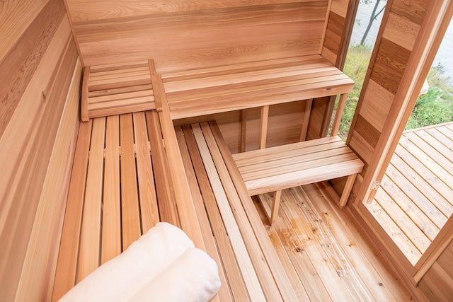The clear Western red cedar interior of a Henki Modern Cabin Sauna.