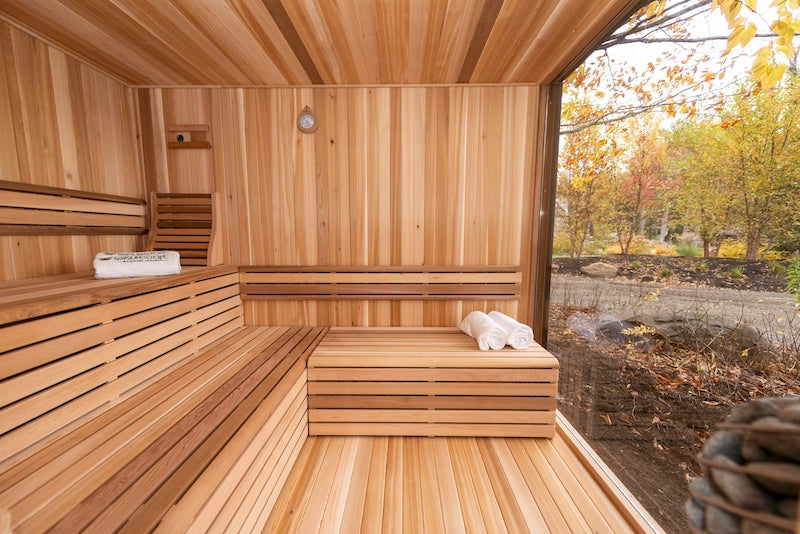 The premium cedar interior of a Neptune Sauna from Henki Sauna Co with sauna accessories.