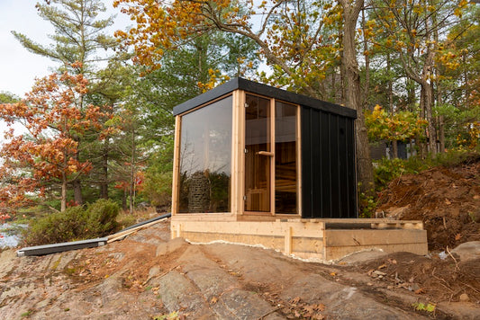 A Pure Cube Orion Sauna on a small deck on rock.
