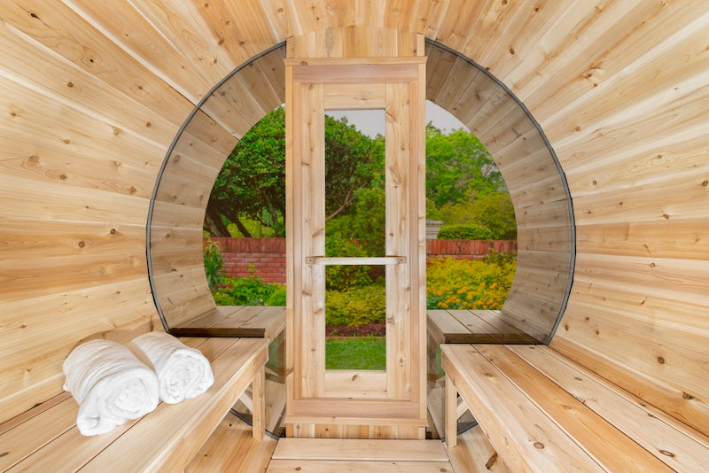 Inside Henki's Panoramic Barrel Sauna with large glass windows and a Cedar Window Sauna Door.