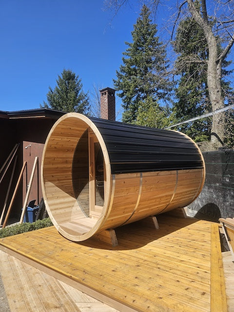 A Henki Panoramic Barrel Sauna on a small deck.