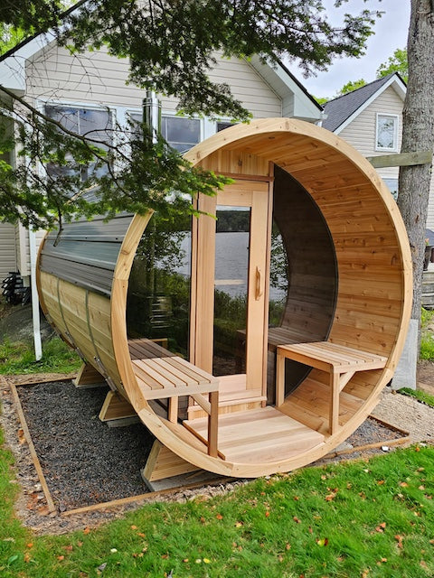A Henki Panoramic Barrel Sauna at a home in Ontario.