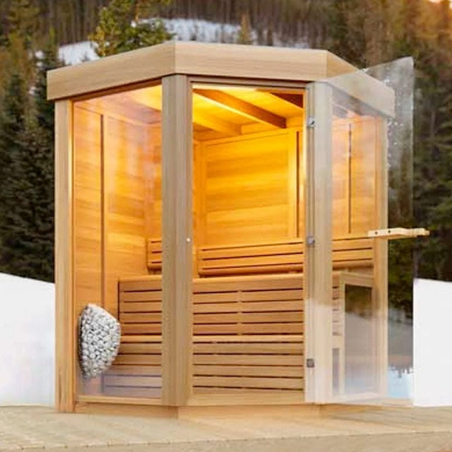 A Pure Cube Trinity Sauna with snow and trees in the background.